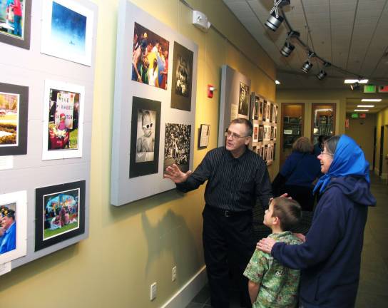 Library hosts photojournalism exhibit Photo by Roger Gavan Professional photographer Robert Demetry welcomes visitors to his photojournalism exhibit, titled ìTalking Pictures, 50 Years of Photojournalism,î in the lower level gallery of the Albert Wisner Public Library.