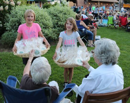 Sesquicentennial festivities feature mustache and beard contest From left, Abigail Kane, 9, and her sister Anna, 7 helped distribute 400 sugar cookies featuring the Sesquicentennial logo to everyone at the concert.