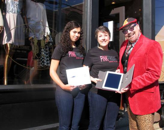 She deserves to win Photo by Roger Gavan Maria Cod-Perez, accompanied by her daughter Gillian, 14, accepts her prize, an iPad, from Tim Mullally, chairman of Pink Friday.