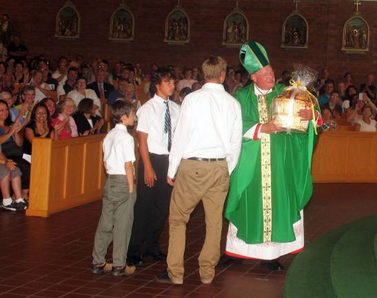 Blessed are the ball players and the gardeners Members of the Pennings Family presented Cardinal Timothy Dolan with a gift basket from their farm and market. ìI hope itís something to eat,î he laughed.