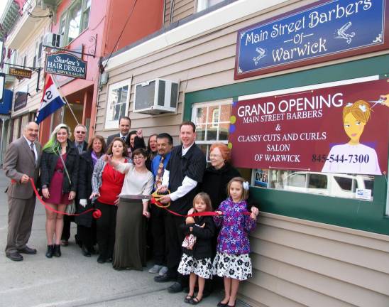 Main Street Barbers and Classy Cuts and Curls opens Photo by Roger Gavan Town of Warwick Deputy Supervisor James Gerstner (left) holds one end of the ribbon as John Figliacconi perform the ceremonial cutting for the grand opening of Main Street Barbers and Classy Cuts and Curls of Warwick.