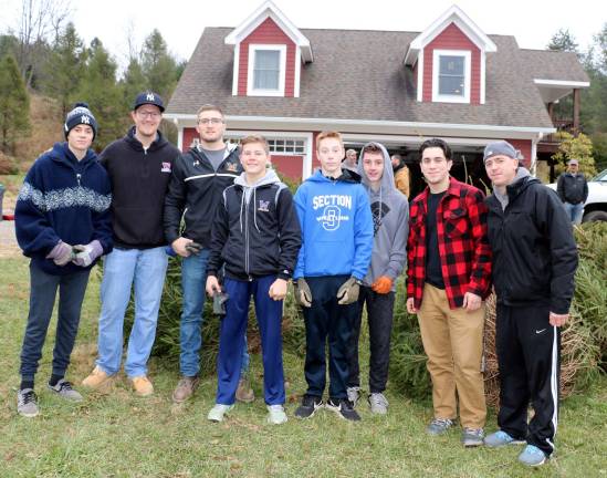 Warwick Valley wrestlers raise funds from sale of Christmas trees Photo by Roger Gavan On Sunday, Dec. 3, Junior Varsity Coach Jeff Jacobson (second from left), Varsity Coach Phil Szumlaski and members of the Warwick Valley Wrestling Program teams sold Christmas Trees at Edward's Tree Farm off Amity Road.