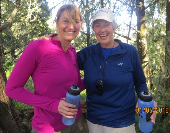 YvonneVandenberg and her aunt, Yvonne Reneman, pause for a photo during their first break of the day while hiking from Big Tree Camp to Shira Camp 1 en route to the summit of Mt. Kilimanjaro.
