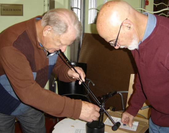 Sustainable Warwick chair Geoff Howard (right) watches attentively as Edwin Winstanley repairs a lamp at the first Repair Cafe on Nov. 19.