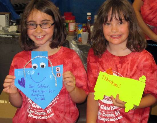 Good deeds, near and far Campers Sammy Homer and Ava Meyers, 10, proudly show the cards they made for soldiers in Israel in Chabadís Camp Gan Israel of Orange County.
