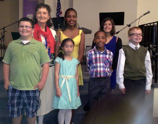 Eight young pianists perform Standing in back, from left to right, are: Piano instructor Margaret Korczynski and young musicians Isabelle Marseille and Grace Whittaker; front, from left to right, are: Front: Brian McKinnon, Sarah Werner, Olivier Marseille and Derek Koch. Not pictured are Olivia Coyle and Ropy Coyle.