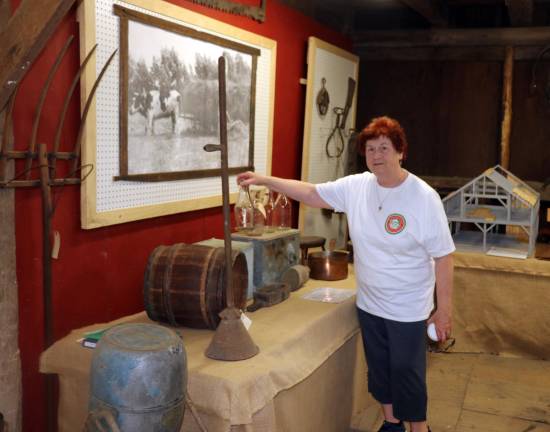 Volunteer Peg Ross described some of the early 19th and 20th century agricultural items essential to dairy and other farming in this area.