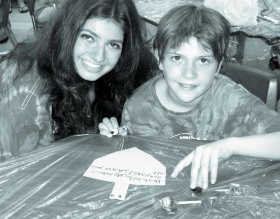 Good deeds, near and far Joey Melillo, 10, of Monroe, creates a card for a soldier in Israel in Camp Gan Israel. He is pictured with counselor Chana Yiftach of Los Angeles.
