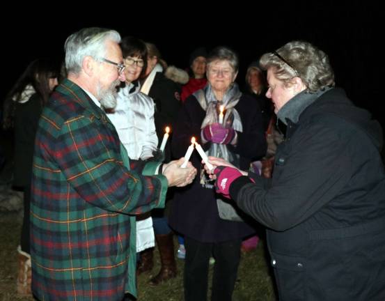 Community connections At the conclusion of the event candles, which had been handed out to the approximately 75 adults in the families that attended, were lit as a symbol of joy and life-giving power.