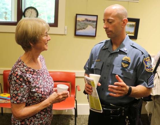 Warwick Police hold 'Coffee with a Cop' at Albert Wisner Public Library Joan Noonan chats with Officer Jim Barnnett.