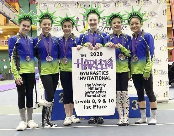 Florida. Orange County Sports Club Coach AlanHatch recognized at Wendy Hillard's gymnastics competition Pictured from left to right are Olivia Martin, Taylor Secord, Lainey Ferrante, Hannah Cann, Kennedy Fisher and Stephanie Kwong.