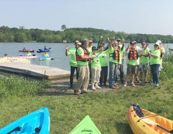 Supervisor Michael Sweeton and Mayor Michael Newhart (in center with red vests) and others welcome arriving kayakers at Wickham Lake.]