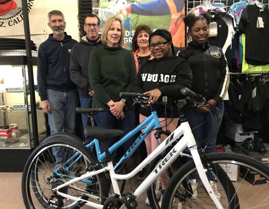 Ride! Rich Cruet, left, owner of The Bicycle Doctor; Don Karlewicz, club treasurer; Carol Kalajian, club volunteer; Pastor Rosey Andrews of Northeast Gateway to Freedom; with bicycle recipients Yazzari Reynolds and Tionna Lawrence and the bikes presented to Northeast Gateway to Freedom.