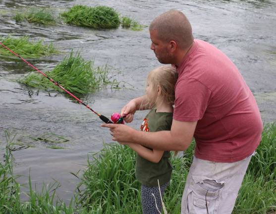 Come fish, go fish Rich Young offers his daughter Makenzie, 6, a few pointers on casting her line.