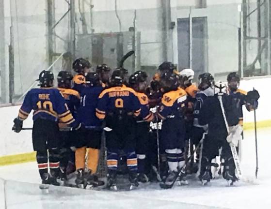 Photo by Ariana D. Den Bleyker WIHC JV Wizards form around the goal for pre-game rally at the Kiwanis Ice Arena, in Saugerties last October.