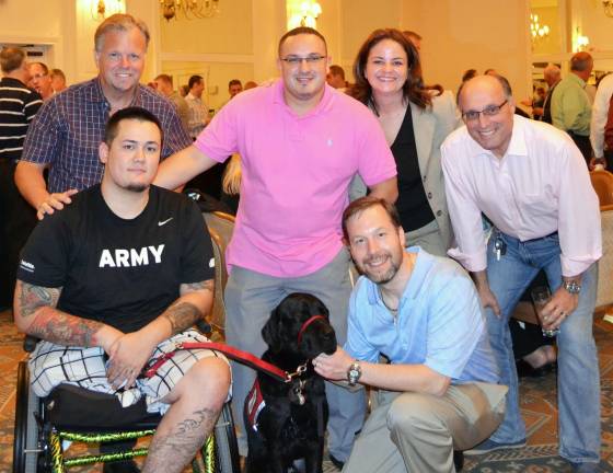 ShopRite raises $300,000 to benefit veterans Provided photo Front, from left to right: U.S. Army Spc. Andy Kingsley, 82nd Airborne Division, and his service dog Ritchie, pose with Tom Urtz, vice president of human resources and community affairs, ShopRite Supermarkets; and back, from left: Mark Filipkowski, Tower of Hope; Bayardo Villegas, store director; Patricia Cruz, community relations manager; and John Dearani, vice president of operations, ShopRite Supermarkets.