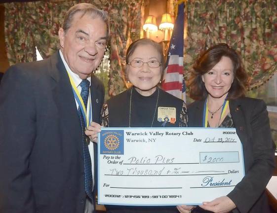 During the evening Rotarian Stan Martin, Citizen of the Year co-chair, joined Carole Tjoa (center), Rotary's District Polio Plus chair, as she accepted a $2,000 donation from Warwick Valley Rotary President Tina Buck.