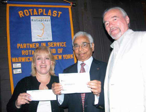 Rotary’s humanitarian efforts Photo by Stan Martin Rotary President John Buckley, right, recently presented a $1,200 check to nurse Kathy Kruger, left, to cover the cost of reconstructive cleft palate operations and treatment, and a $1,000 check to Dr. Tansukh Dorawala, Rotary District 7210 Governor, on behalf of Pure Water for the World.