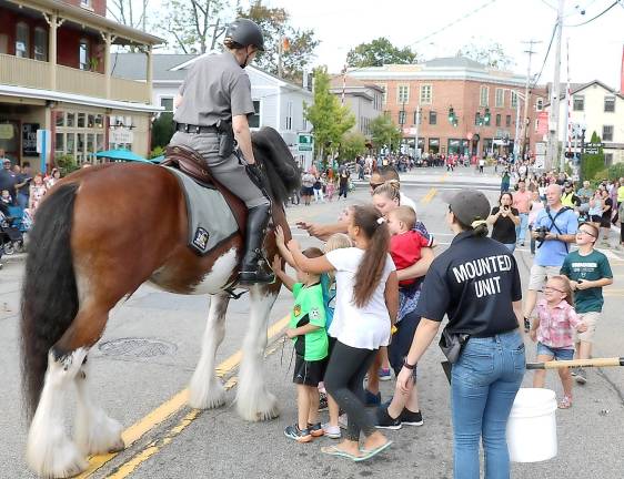 150 years in the making An officer of the New York State Troopers Mounted Unit invited the children to come out and pet the horse.