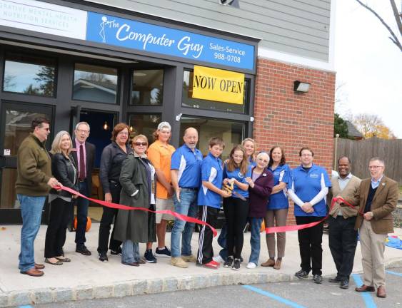 Photo by Roger Gavan On Nov. 7, Town of Warwick Supervisor Michael Sweeton (right) and members of the Warwick Valley Chamber of Commerce joined owner Kevin Brand (center), his wife, Roxanne, family and staff for a ribbon-cutting ceremony to celebrate the new store's grand opening.