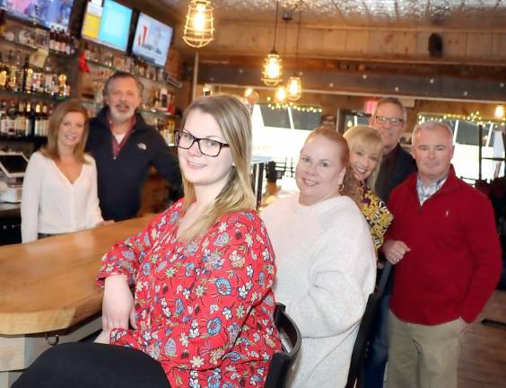 Gathered around the authentic barn wood bar at Mattingly’s Tavern to formalize plans for the February 27 Warwick Valley Chamber of Commerce Business Mixer are from left, Mattingly’s Tavern Bartender Erin Tarwater, Proprietor Thomas Mattingly, Warwick Valley Chamber of Commerce Office Manager Bea Arner, Office Assistant Lori Cosgrove, Programs Chair Janine Dethmers, Chamber President James Mezzetti and Executive Director Michael Johndrow.