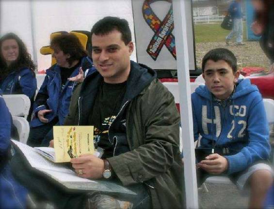 Scouts sponsor An Evening with Jesse Saperstein Jesse Saperstein signs one of his books at an autism awareness function.