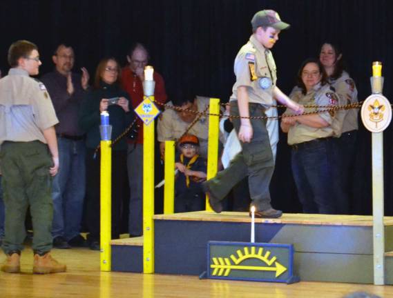 Cub Scout Pack No. 177 celebrates Blue and Gold dinner The high point of the evening was the Arrow of Light Crossover Ceremony for the Weblos II when they walk over a bridge symbolically transitioning into becoming a Boy Scout.