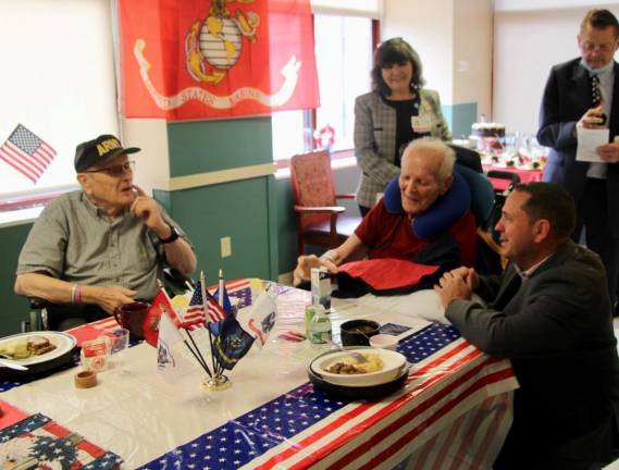 Neuhaus speaks with Roger Carroll (Army hat) and Robert Dillan at Schervier Pavilion. Carroll served in the U.S. Army and U.S. Navy. Dillan is a navy veteran.