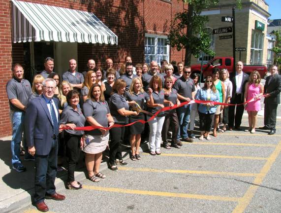 WVT Photo by Roger Gavan On Aug. 4, Town of Warwick Supervisor Michael Sweeton (far right) and members of the Warwick Valley Chamber of Commerce joined the company's General Manager Marie Corlett and Product Manager Jean Beattie (center) along with other employees of the firm to celebrate the return to its original name, Warwick Valley Telephone, with a ribbon-cutting ceremony.