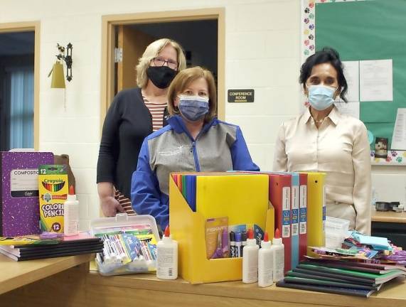 Joy Housberg (center), Administrative Assistant at St. Anthony Community Hospital, delivers school supplies donated by hospital staff to Sanfordville Elementary School the day before school. St. Anthony also donated supplies to Pine Island and Park Avenue Elementary, as well as elementary schools in Florida and Greenwood Lake. Provided photo.