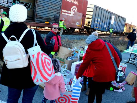 Local residents stop by to drop off their gifts of toys for needy children.