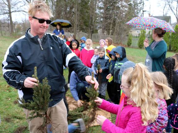 Village of Warwick celebrates Arbor Day at Stanley-Deming Park Before the children returned to class, Craig Wadeson from Wadeson's Home Center, handed out evergreens donated by his company.