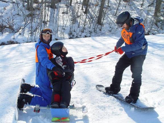 Mountain Creek provides winter recreation for visitors with special needs Mountain Creek Program Staffer Martin and Director Tim Stone get Nick ready for a run on the Horizon Slope. Photo: Dr. John T. Whiting