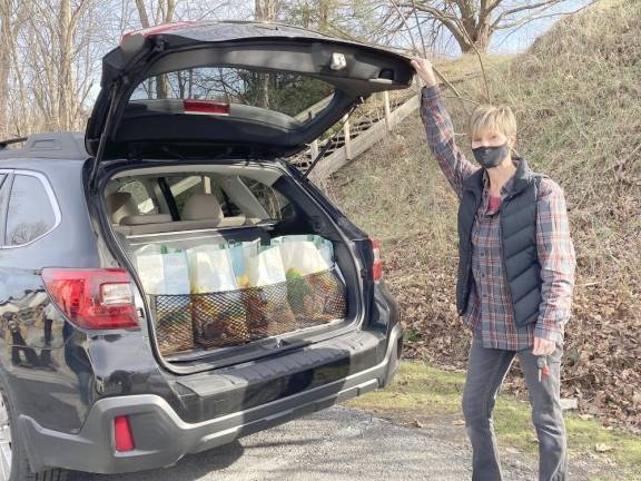 Volunteer Kerry Schmidt Loads her car with holiday food packages going to migrant farmworkers and their families. Provided photos