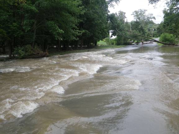 Flooding: The good, the bad, and the ugly Photo by Ginny Privitar Water gushes down Stevens Place in Chester.