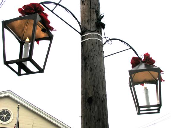 Custom-made lanterns add charm to the village Custom-made lanterns decorate Village of Warwick during holiday season WARWICK ñ This year, for the first time, holiday decorations along Main Street have included new lanterns, designed and manufactured by John Redman, to enhance the Villageís Historic District.