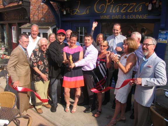 La Piazza Wine Bar & Martini Lounge opens Photo by Roger Gavan Surrounded by members of the Warwick Valley Chamber of Commerce, friends and business neighbors, owner Tony Sylaj, his wife, Lauren, and partner Nick Ahmetaj cuts the ribbon held by Town of Warwick Supervisor Michael Sweeton (far left) and Mayor Michael Newhard (far right).