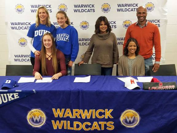 Two Warwick Valley High School scholar athletes sign National Letters of Intent Photo by Heidi Thonus Pictured from left to right are Kaeli Thompson, seated, and her mother Heather Thompson and sister Kristin, a sophomore, and Taina Gamory, seated, with her parents Mary and Tim Gamory. Thompson signed a National Letter of Intent to attend Duke University and participate in track and field while Gamory signed a National Letter of Intent to attend the University of Hartford where she will play lacrosse.