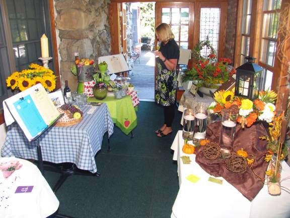 Fashion show raises $8,000 for Warwick in Bloom Photos by Roger Gavan The Warwick in Bloom Fall Fashion Show also featured a silent auction, which also showcased the talents of local designers who were assigned a different month of the year as a theme for each table display.