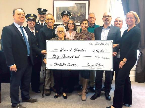 Gathered in the office of Warwick Valley Financials from left are: CPA Jeff Alario, president of Alario &amp; Associates; Melissa Stevens, president of the Warwick Fire Department; Captain Joseph Ingui of Raymond Hose Co 2; Donald Pizza, great nephew; Louise K. Gilbert, 2nd Lt. John Knuth of Raymond Hose Co 2; the Rev. Jennifer Morrow of Warwick’s United Methodist Church; Sharlene Miller-Pizza, great niece; Frank Cassanite, captain of the Warwick Ambulance Corps; Ken Ford, president of Warwick Valley Financial Advisors; Dylan Gerstner, president of Raymond Hose Co. 2; and Femi Ford of Warwick Valley Financials.