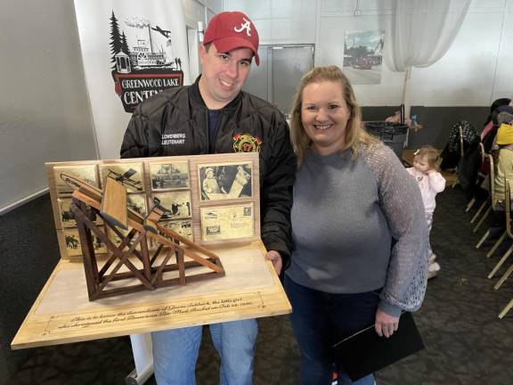 RK3 Jackie and Jon Lowenberg stand behind a scale model of the Gloria rocket airplane launch created by Greenwood Lake resident Tony Donato.