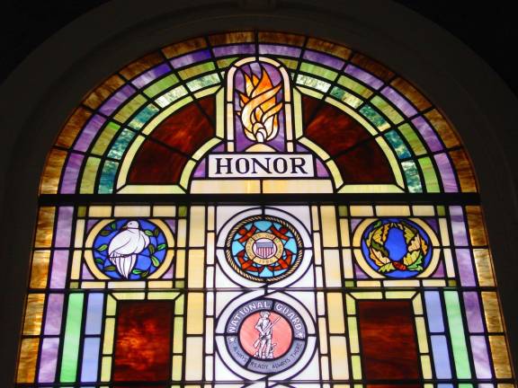 Honoring those who have served This detail of shows the top part of the stained glass window created and installed by the Downs-Behle Studio of Warwick in the Blooming Grove United Church of Christ.