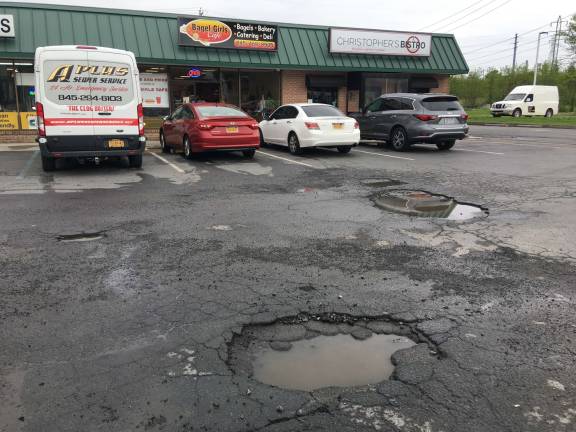 Eyesores and hazards present a thorny problem for towns The Chronicle's Pothole Watch has turned its focus on the Quickway Plaza on Brookside Avenue in Chester, which is sporting some rather massive craters. (Photo by Erika Norton)