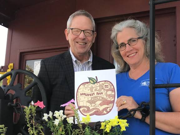 Connie Hegner, the creator of the 2019 Applefest T-shirt design,Â is congratulated by Michael Johndrow, executive director of the Warwick Valley Chamber of Commerce.