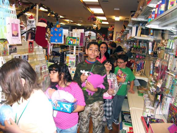 Shopping with the pastor The children picked paper doll cutouts describing the gender and size of a child so that they could select proper toys.