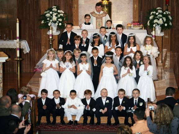 First communion at Holy Rosary Church Photo by David Malantic Pictured here are Rev. Robert J. Sweeney, pastor at Holy Rosary Church in Greenwood Lake, altar servers Michaela and Mary Calandra and the 27 children who received their First Holy Communion on Saturday, April 28, in Greenwood Lake.