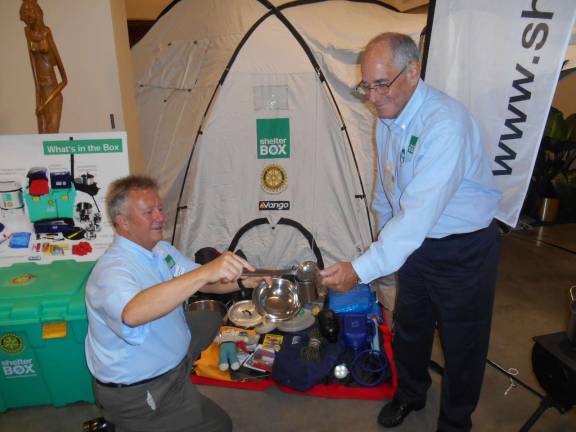 Warwick Rotarians join relief efforts for typhoon victims Rotarian Shelter Box Ambassadors Louis Turpin and Larry Palant demonstrate some of the items in a Shelter Box during Rotary International Day at the United Nations earlier this month.