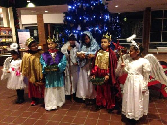 Celebrating El Dia De Reyes Provided photo The children, who were dressed as Mary, carrying the baby Jesus, Joseph, angels and the Three Wise Men, posed for a photograph in their costumes.