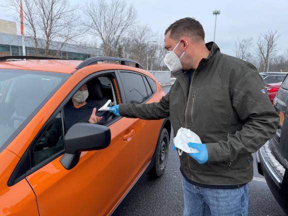 Update: County’s free COVID-19 test distribution ends early County Executive Steve Neuhaus distributing supplies. Photo provided.