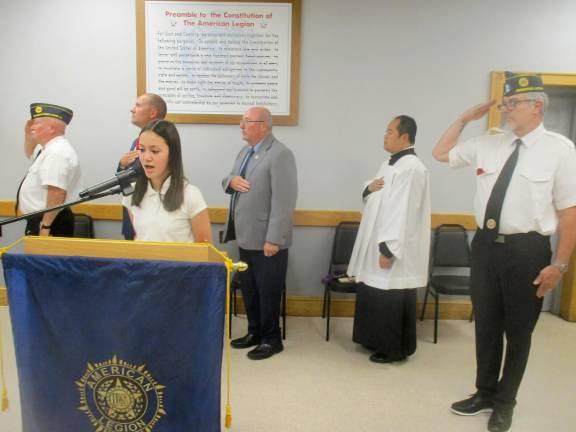 American Legion ceremony honors departed comrades . Skylar Clifford, 12, of Greenwood Lake, sings at the ceremony.